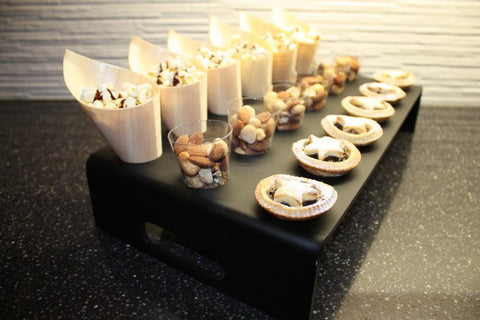 Clear 18 hole cone and cup stand with handles on sides filled with food